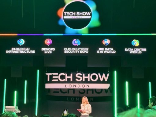 Tech Show London 2026 stage featuring speaker presenting topics on cloud and AI infrastructure, cybersecurity, and data center innovations, with vibrant lighting and event branding.